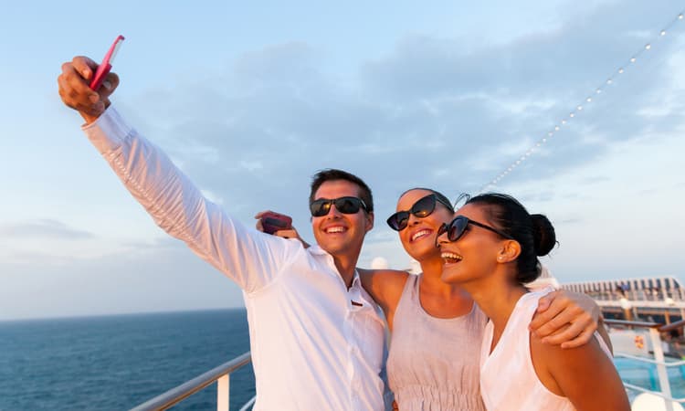 a group of friends taking a selfie on a cruise ship