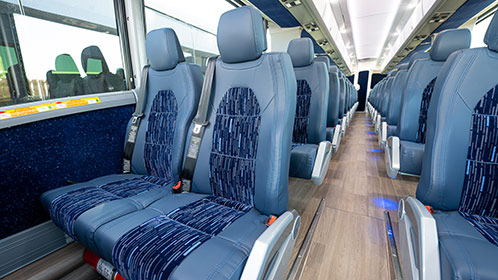 Reclining seats and seatbelts in charter bus